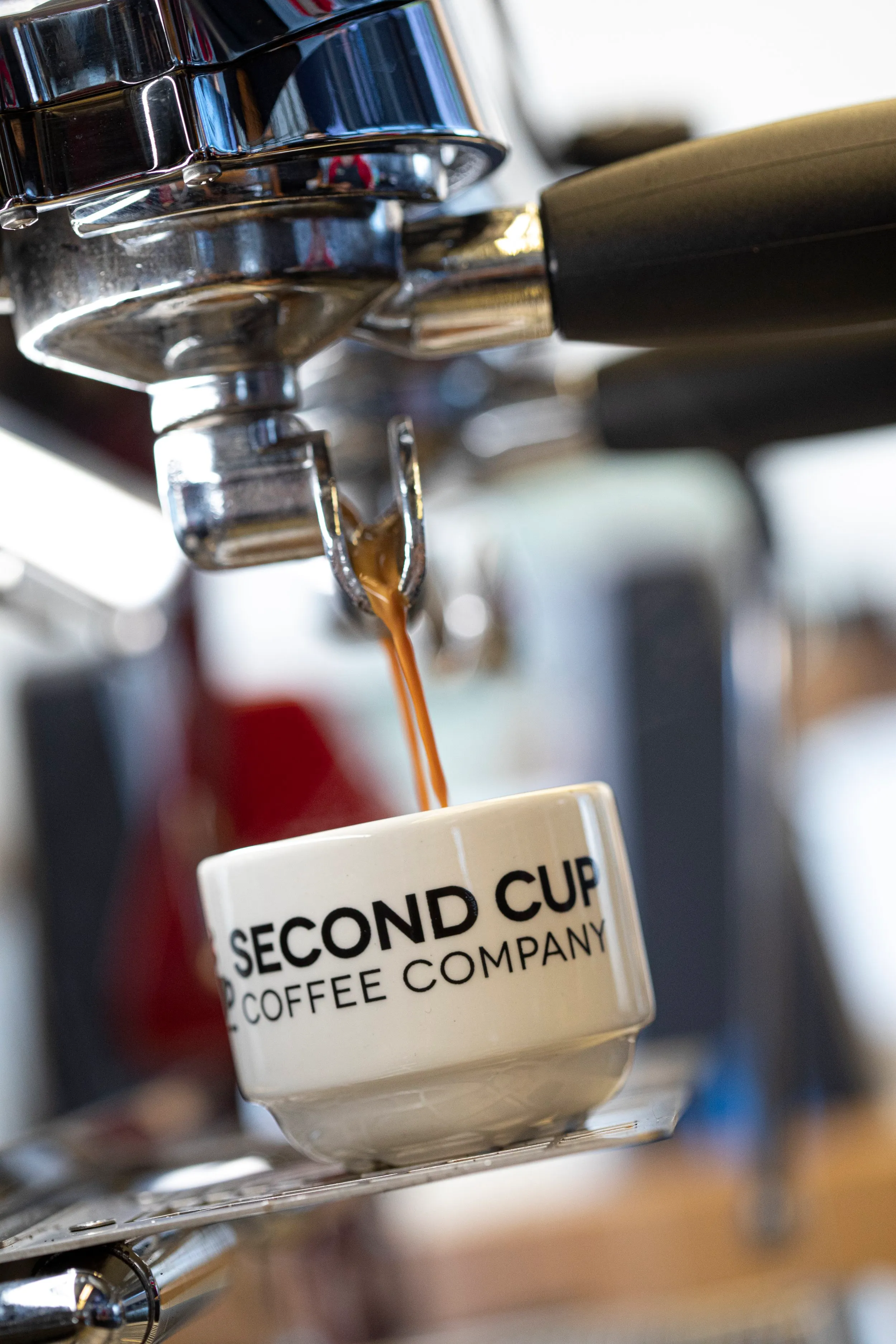 Espresso pouring into a Second Cup Coffee Company cup
